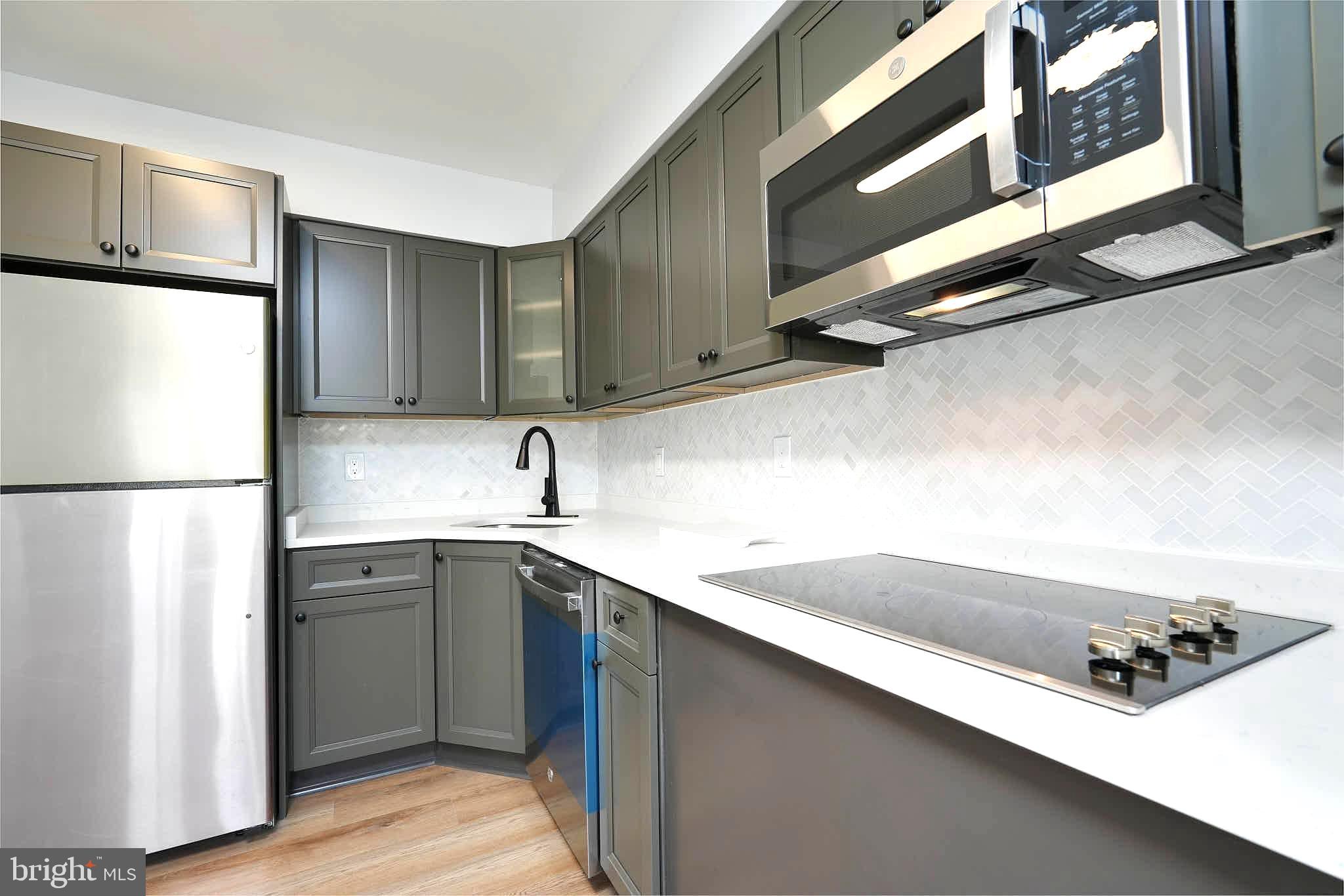 7938 Brighton Way Manassas, VA 20109 - Photo 11 of 26 a kitchen with a sink a refrigerator and cabinets