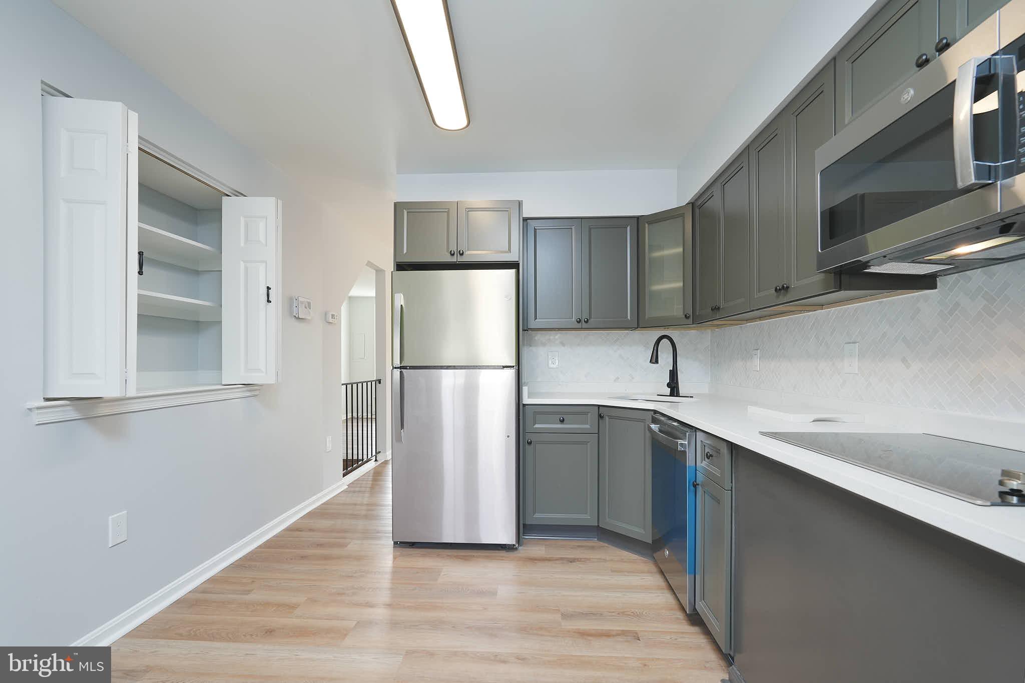 7938 Brighton Way Manassas, VA 20109 - Photo 13 of 26 a kitchen with a refrigerator sink and cabinets