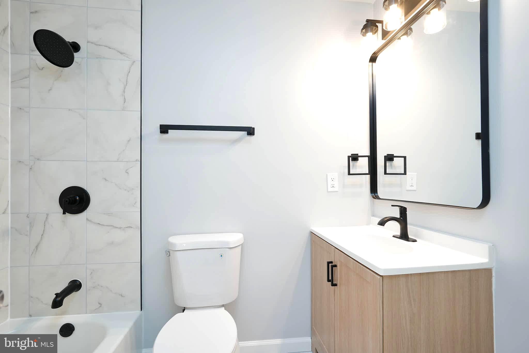 7938 Brighton Way Manassas, VA 20109 - Photo 19 of 26 a bathroom with a sink a toilet and shower