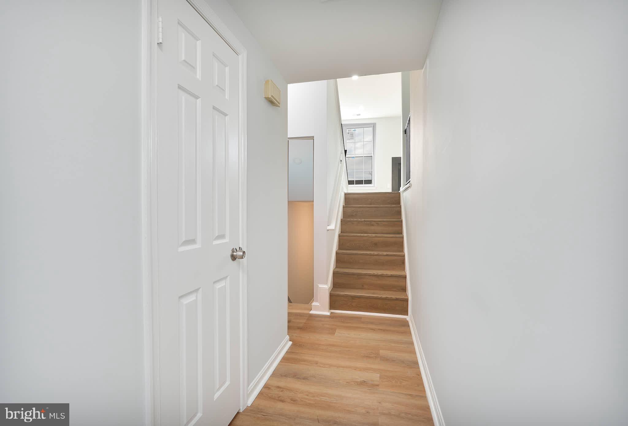 7938 Brighton Way Manassas, VA 20109 - Photo 2 of 26 a view of a hallway with wooden floor and entryway