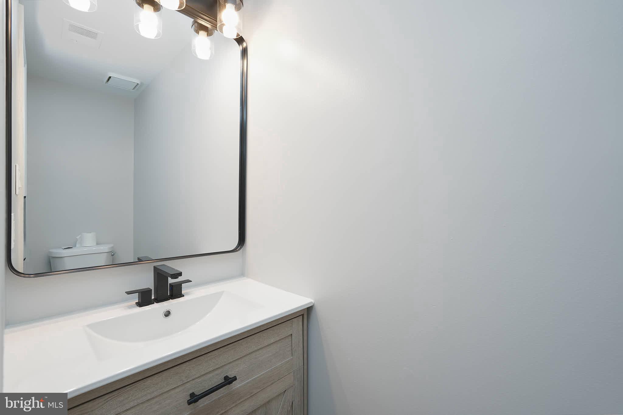 7938 Brighton Way Manassas, VA 20109 - Photo 24 of 26 a bathroom with a sink and a mirror