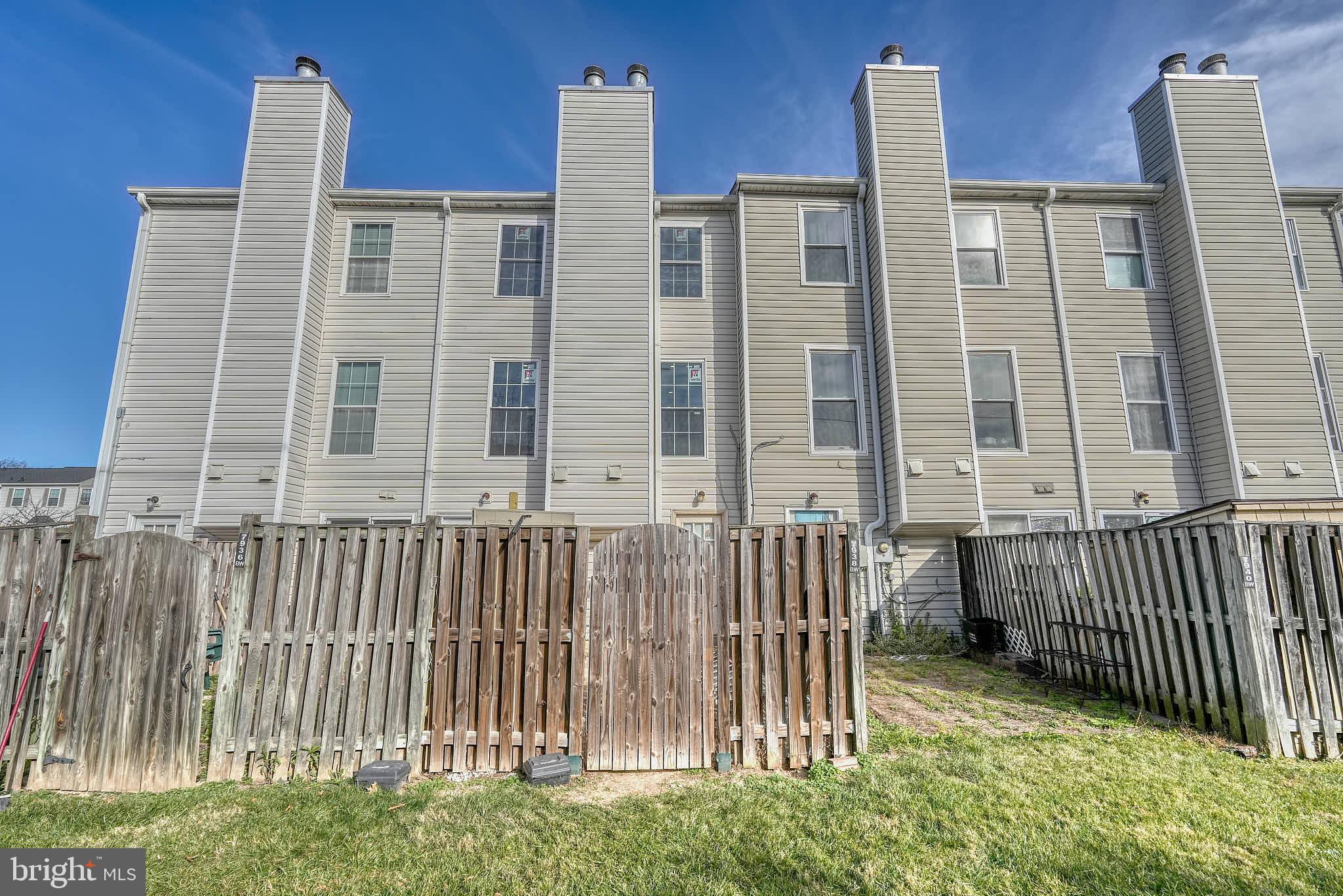 7938 Brighton Way Manassas, VA 20109 - Photo 26 of 26 a view of a brick building next to a yard