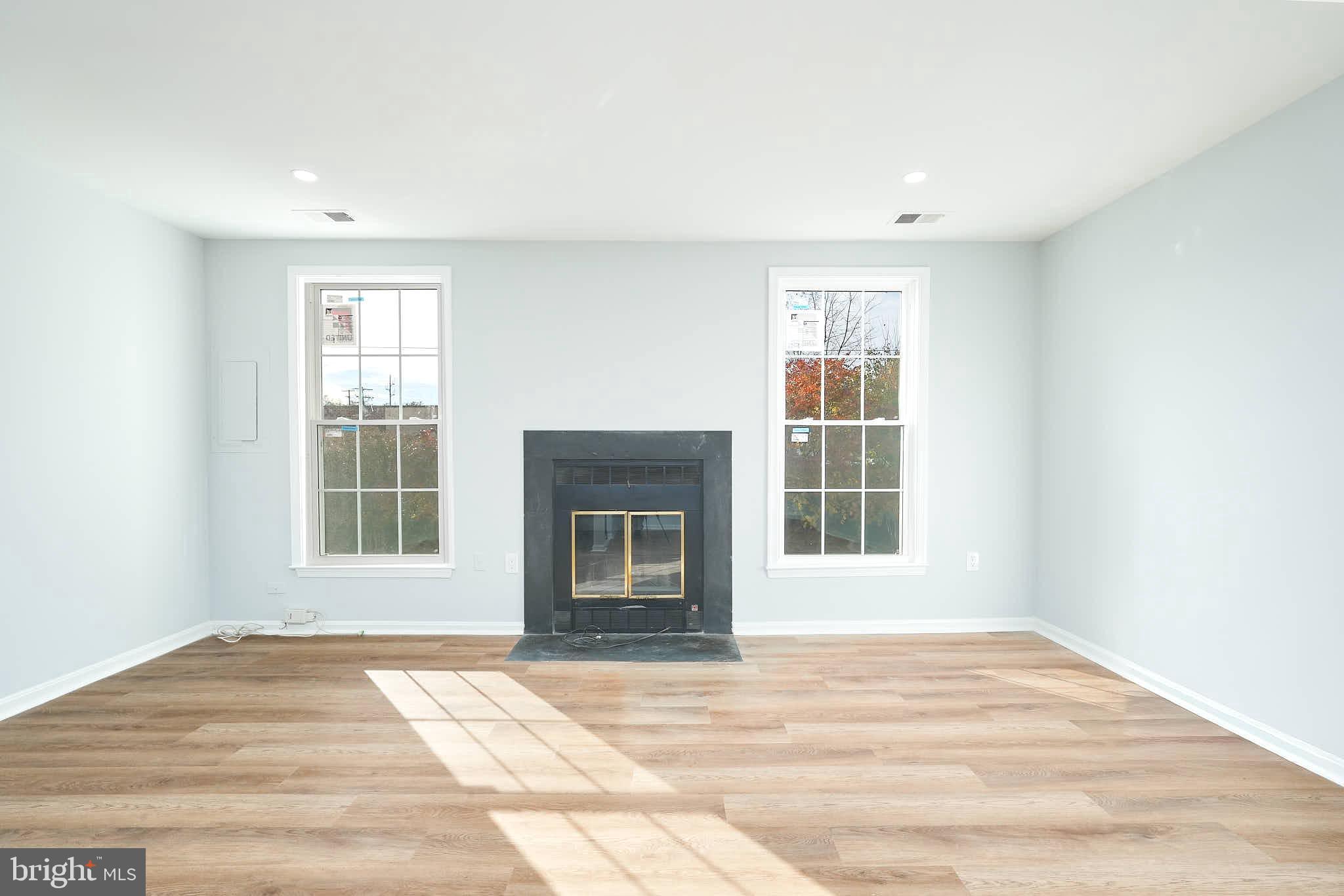 7938 Brighton Way Manassas, VA 20109 - Photo 3 of 26 a view of an empty room with a window and a kitchen