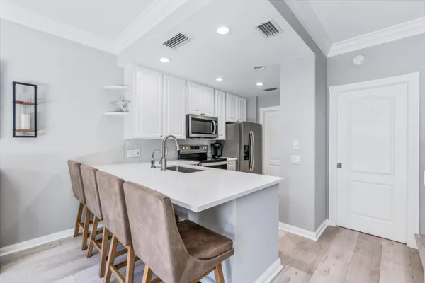 a view of kitchen with cabinets table and chairs