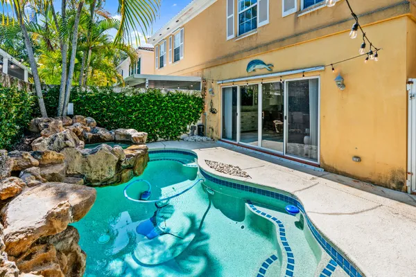 a view of backyard with swimming pool and outdoor seating