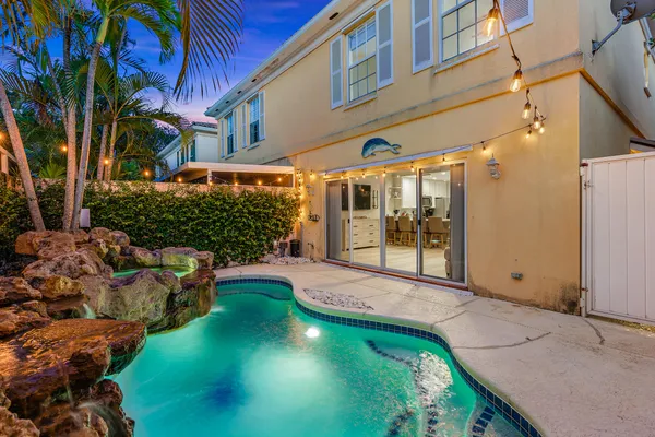 a front view of a house with a yard and outdoor seating