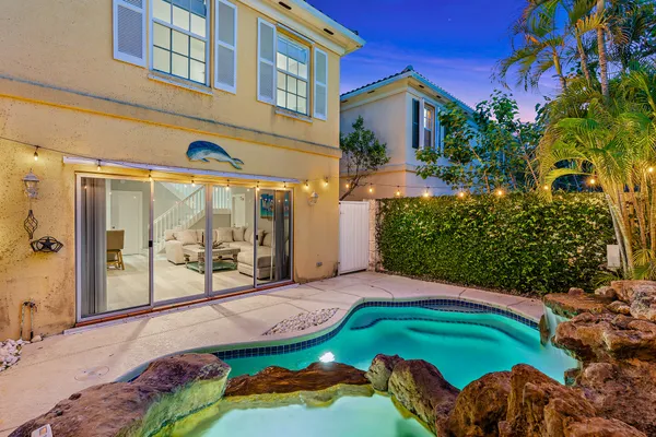 an aerial view of a house with yard swimming pool and outdoor seating