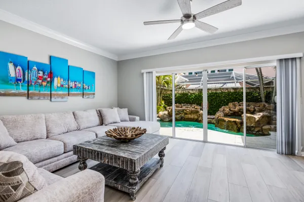 a living room with furniture and a floor to ceiling window
