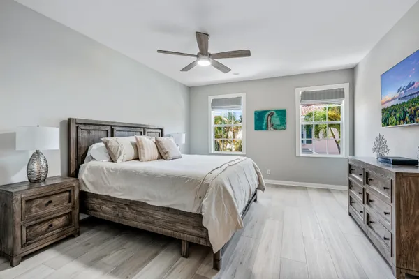a bedroom with a bed and a tv on the dresser