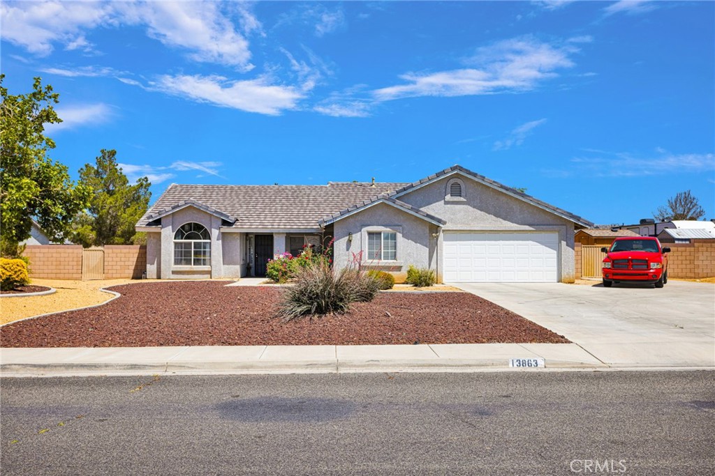 13863 Coachella Road Apple Valley, CA 92307 - Photo 1 of 53 a front view of a house with a yard and garage
