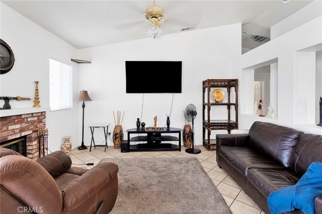 13863 Coachella Road Apple Valley, CA 92307 - Photo 14 of 53 a living room with furniture and a flat screen tv