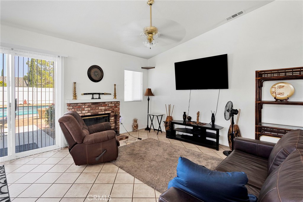 13863 Coachella Road Apple Valley, CA 92307 - Photo 15 of 53 a living room with furniture and a flat screen tv