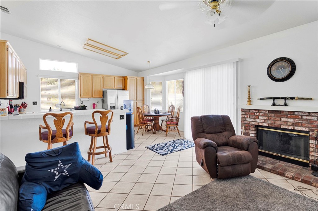 13863 Coachella Road Apple Valley, CA 92307 - Photo 16 of 53 a living room with furniture a flat screen tv and a fireplace