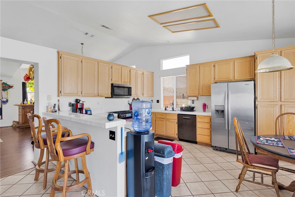 13863 Coachella Road Apple Valley, CA 92307 - Photo 19 of 53 a kitchen with sink refrigerator and cabinets