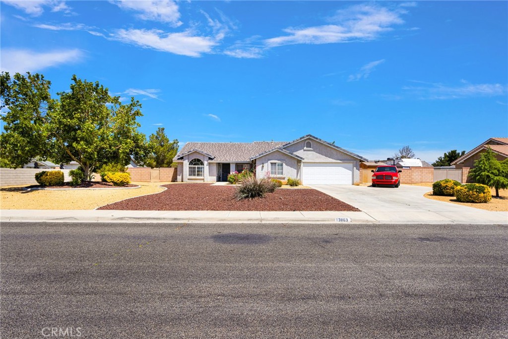 13863 Coachella Road Apple Valley, CA 92307 - Photo 2 of 53 a street view with large trees