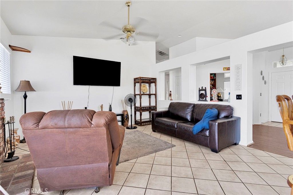 13863 Coachella Road Apple Valley, CA 92307 - Photo 23 of 53 a living room with furniture and a flat screen tv