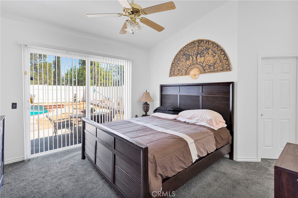 13863 Coachella Road Apple Valley, CA 92307 - Photo 24 of 53 a bedroom with a bed and a chandelier