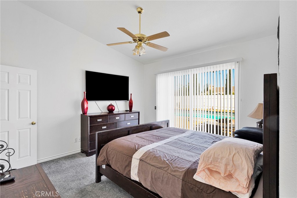 13863 Coachella Road Apple Valley, CA 92307 - Photo 26 of 53 a bedroom with a bed and a flat screen tv