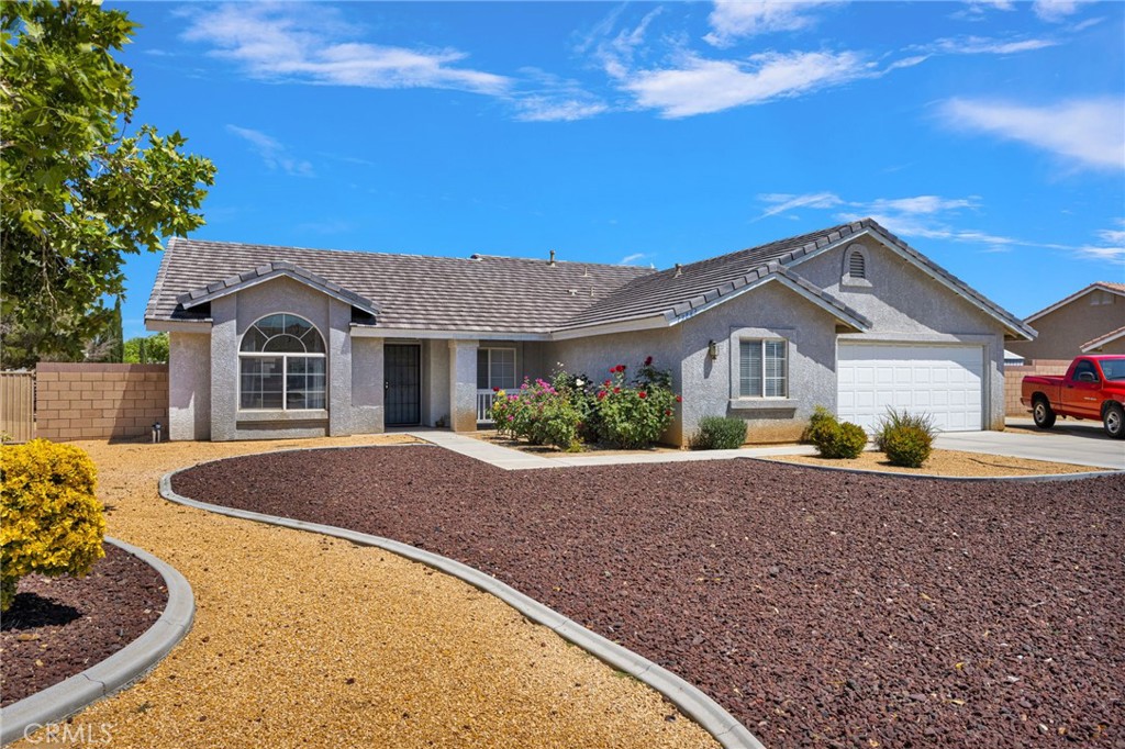 13863 Coachella Road Apple Valley, CA 92307 - Photo 3 of 53 a front view of a house with a yard