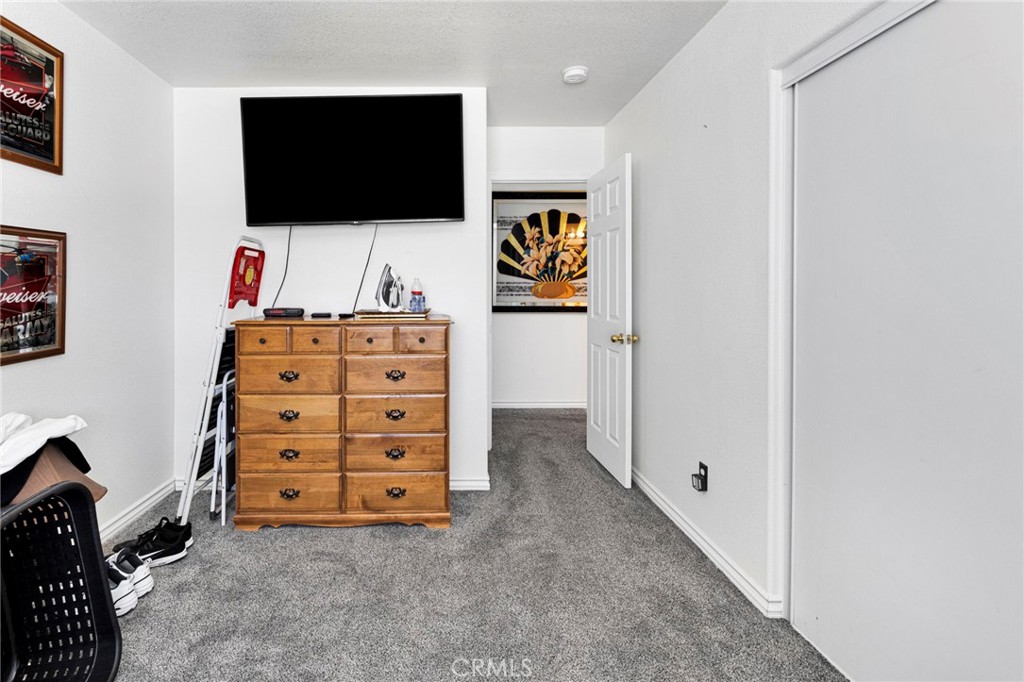 13863 Coachella Road Apple Valley, CA 92307 - Photo 33 of 53 a room with furniture and a flat screen tv