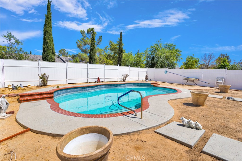 13863 Coachella Road Apple Valley, CA 92307 - Photo 40 of 53 a view of a swimming pool with a patio