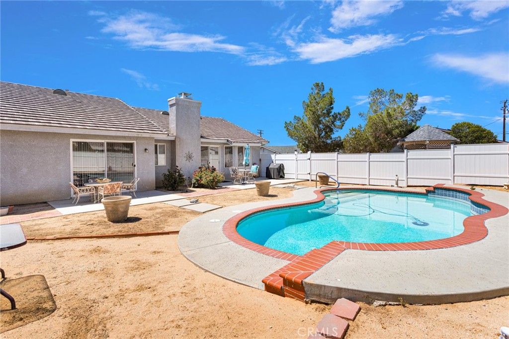 13863 Coachella Road Apple Valley, CA 92307 - Photo 41 of 53 a view of a swimming pool with a patio