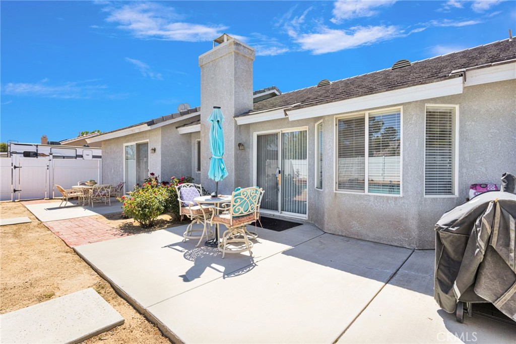 13863 Coachella Road Apple Valley, CA 92307 - Photo 43 of 53 a view of a patio with couches table and chairs and potted plants