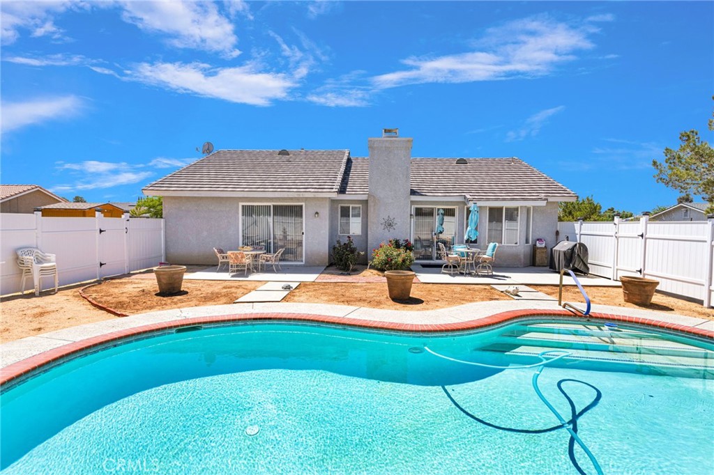 13863 Coachella Road Apple Valley, CA 92307 - Photo 5 of 53 a swimming pool with outdoor seating and yard