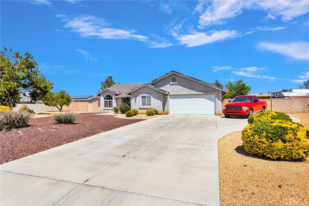 13863 Coachella Road Apple Valley, CA 92307 - Photo 52 of 53 a yellow house with lots of trees in the background