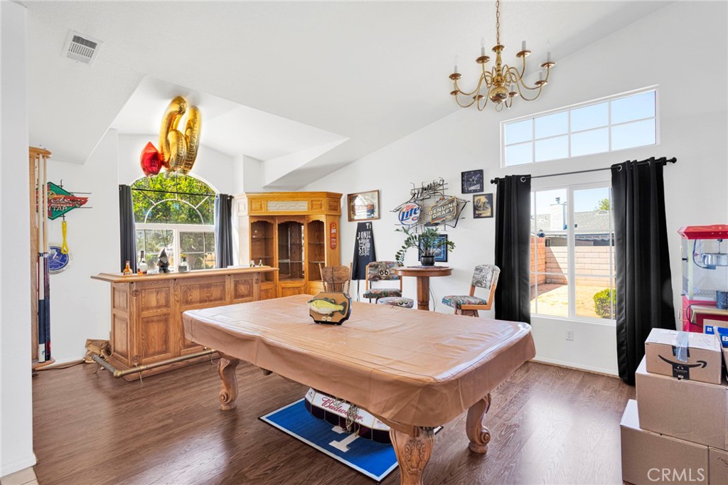 13863 Coachella Road Apple Valley, CA 92307 - Photo 9 of 53 a view of a dining room with furniture a chandelier and wooden floor