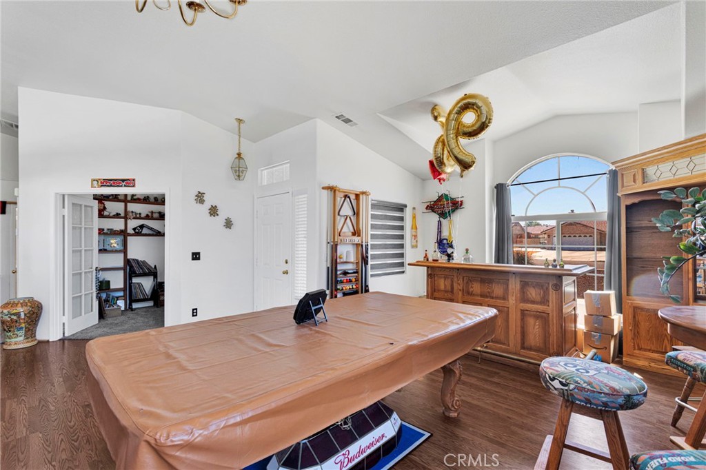 13863 Coachella Road Apple Valley, CA 92307 - Photo 10 of 53 a dining room with stainless steel appliances kitchen island a table and chairs in it
