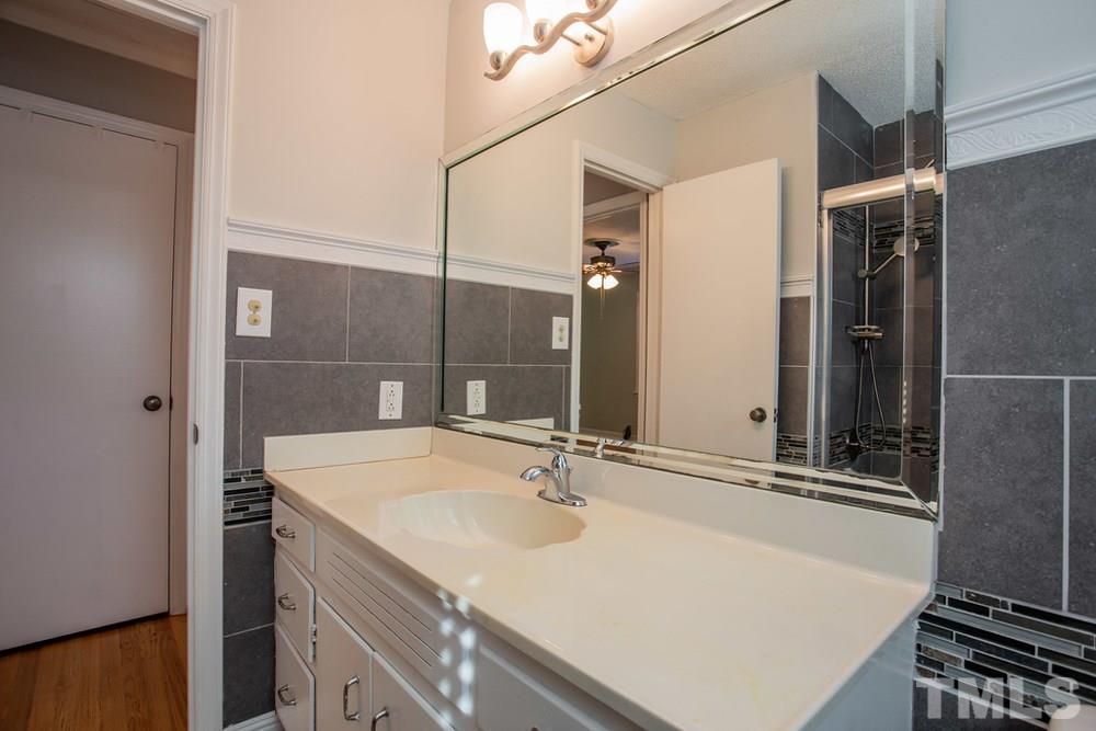4200 Pike Road Raleigh, NC 27613 - Photo 22 of 30 a bathroom with a sink and a mirror