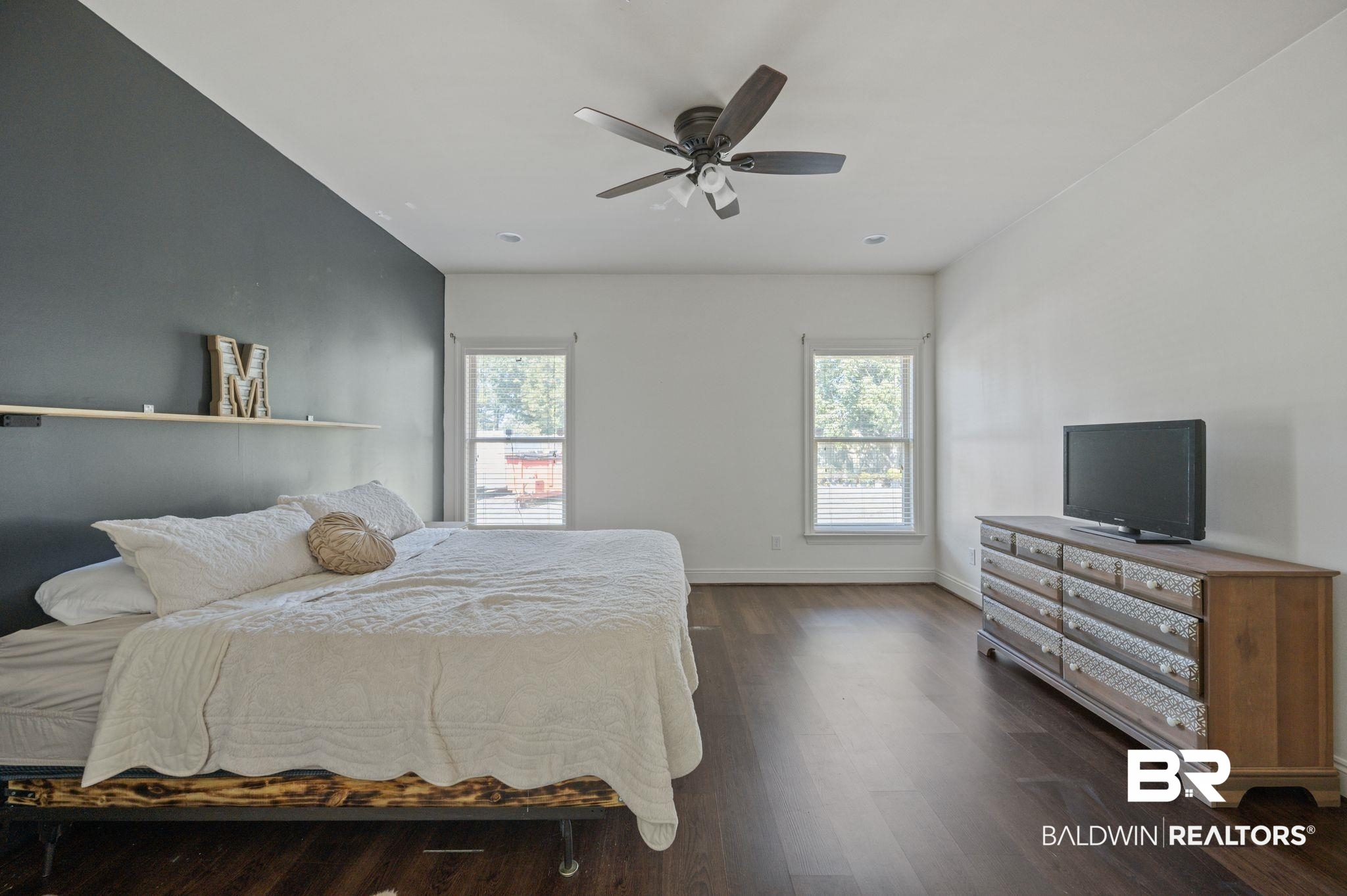 3879 Symphony Way West Semmes, AL 36575 - Photo 22 of 34 Bedroom featuring ceiling fan, multiple windows, and dark hardwood / wood-style floors