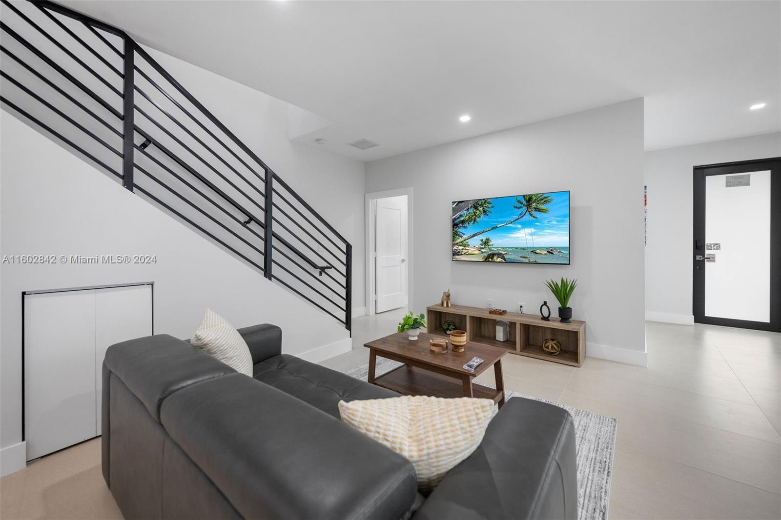 Allapattah Miami, FL 33142 - Photo 11 of 27 a living room with furniture and a flat screen tv