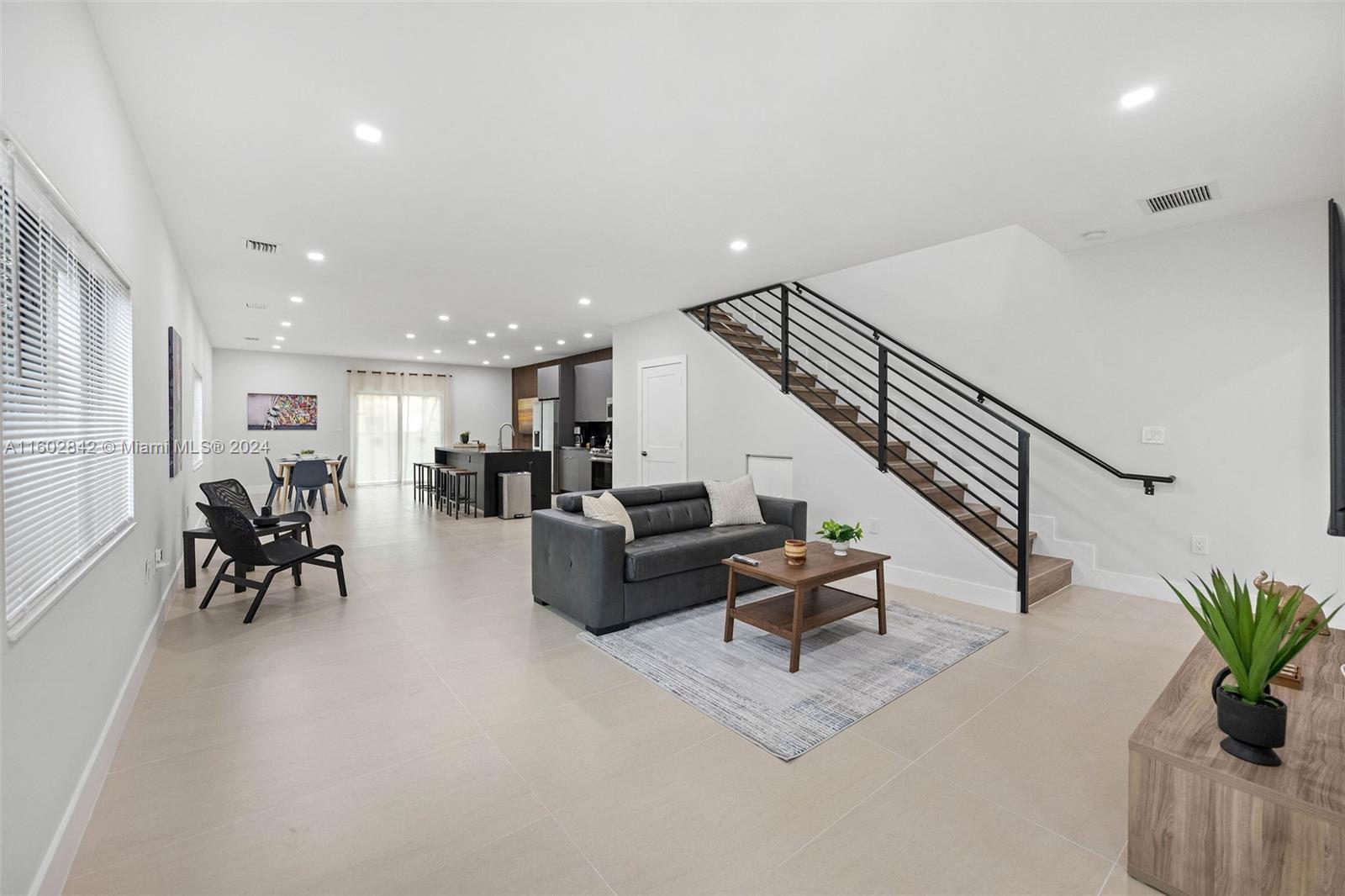 Allapattah Miami, FL 33142 - Photo 12 of 27 a living room with furniture and a potted plant