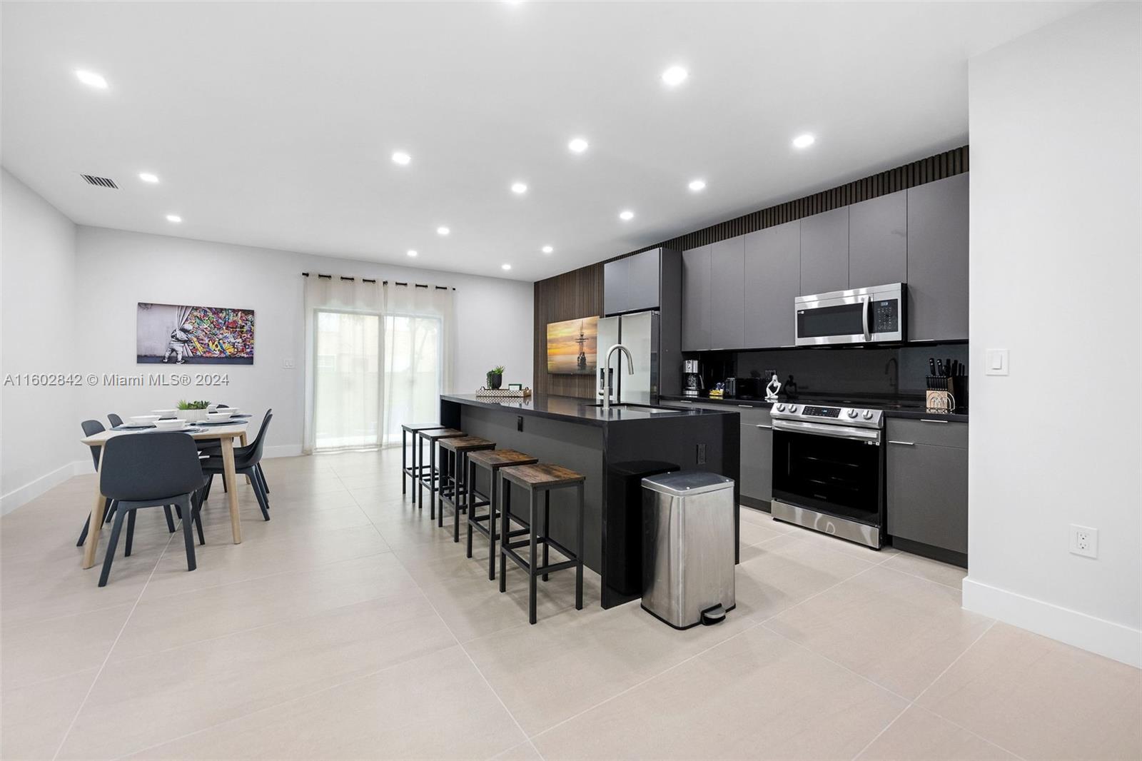 Allapattah Miami, FL 33142 - Photo 7 of 27 a kitchen with stainless steel appliances kitchen island granite countertop a stove a sink a counter top space and cabinets