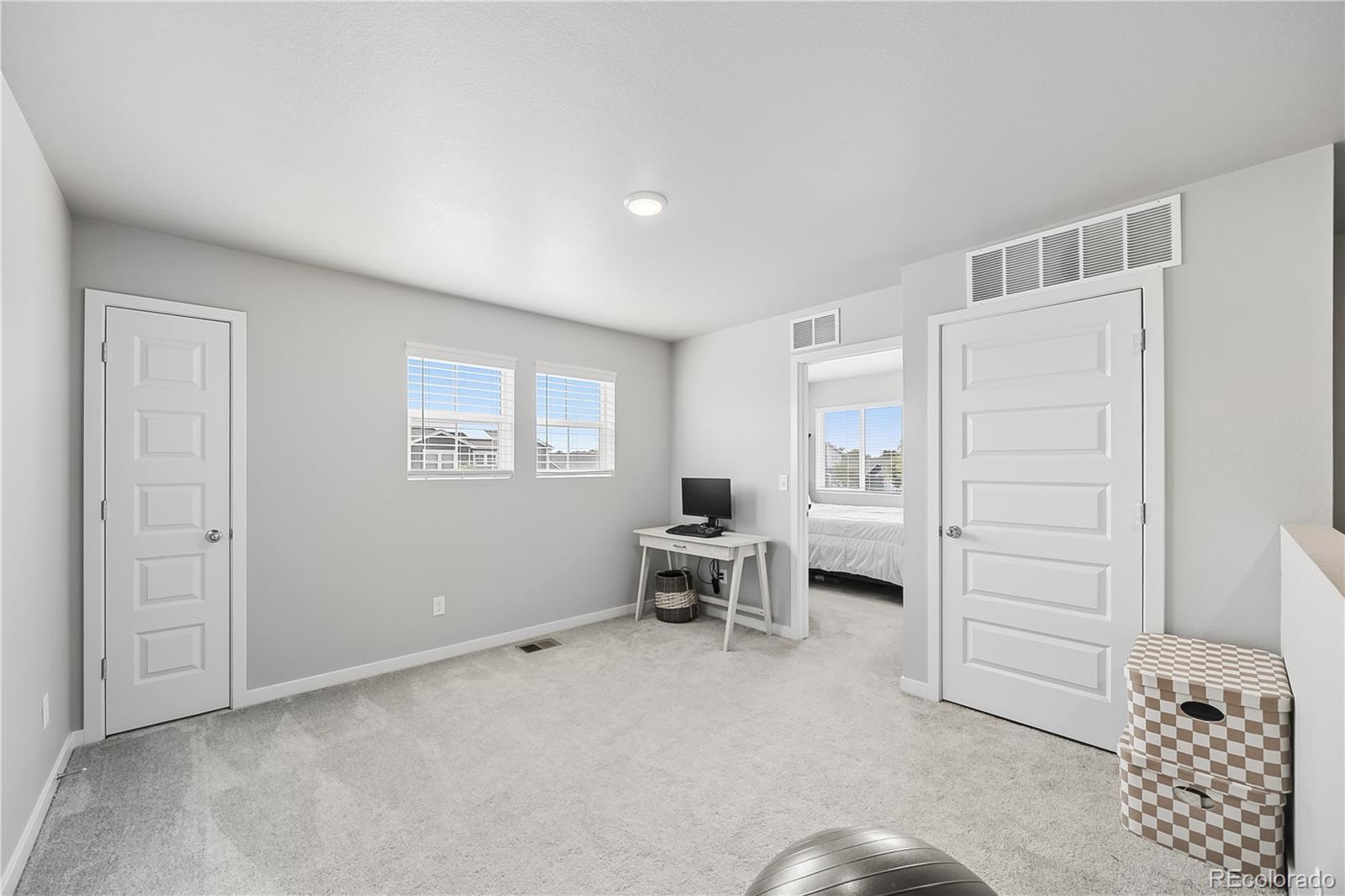 669 South Hoover Avenue Fort Lupton, CO 80621 - Photo 12 of 24 a living room with furniture and a window