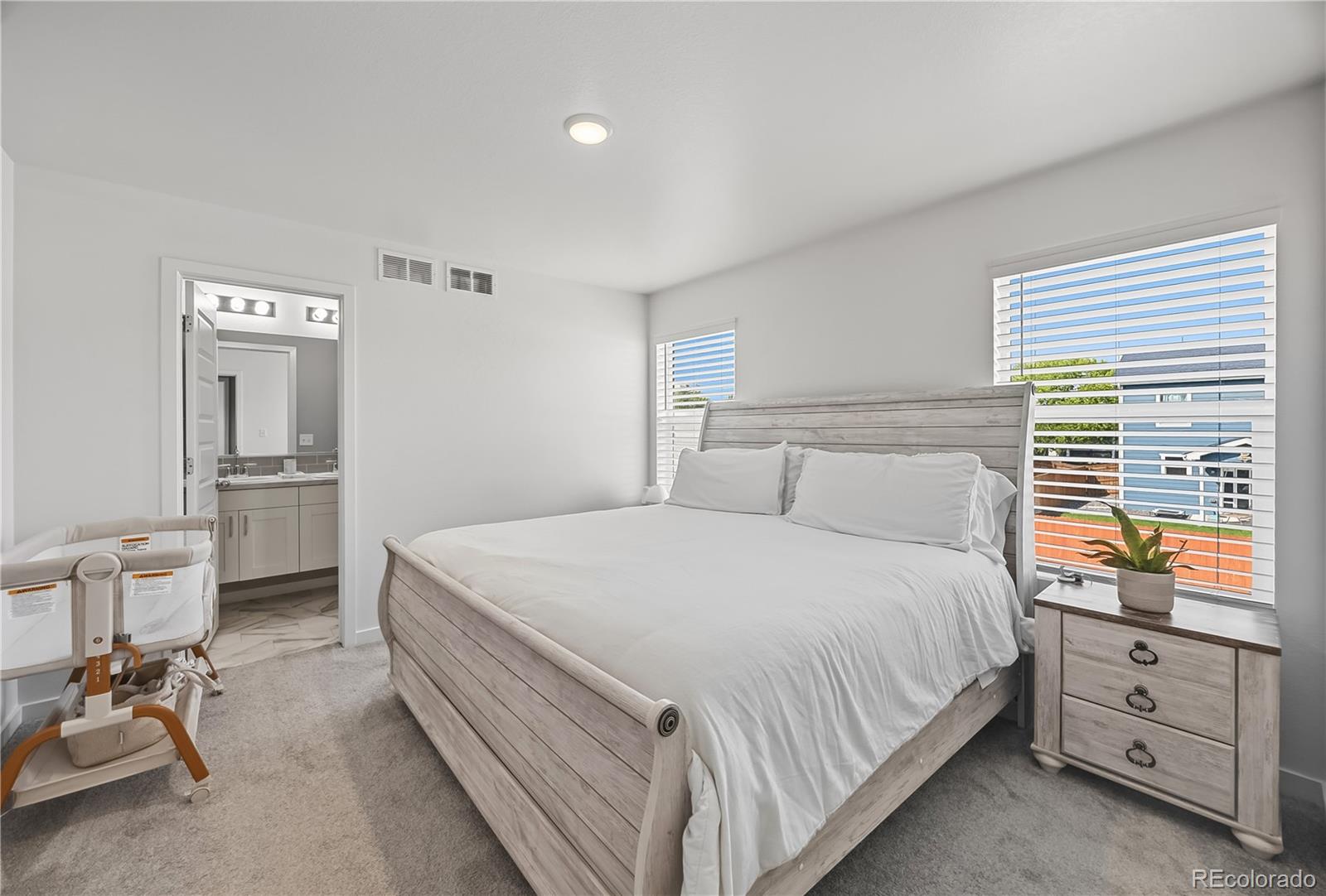 669 South Hoover Avenue Fort Lupton, CO 80621 - Photo 13 of 24 a bed room with a bed and a chair