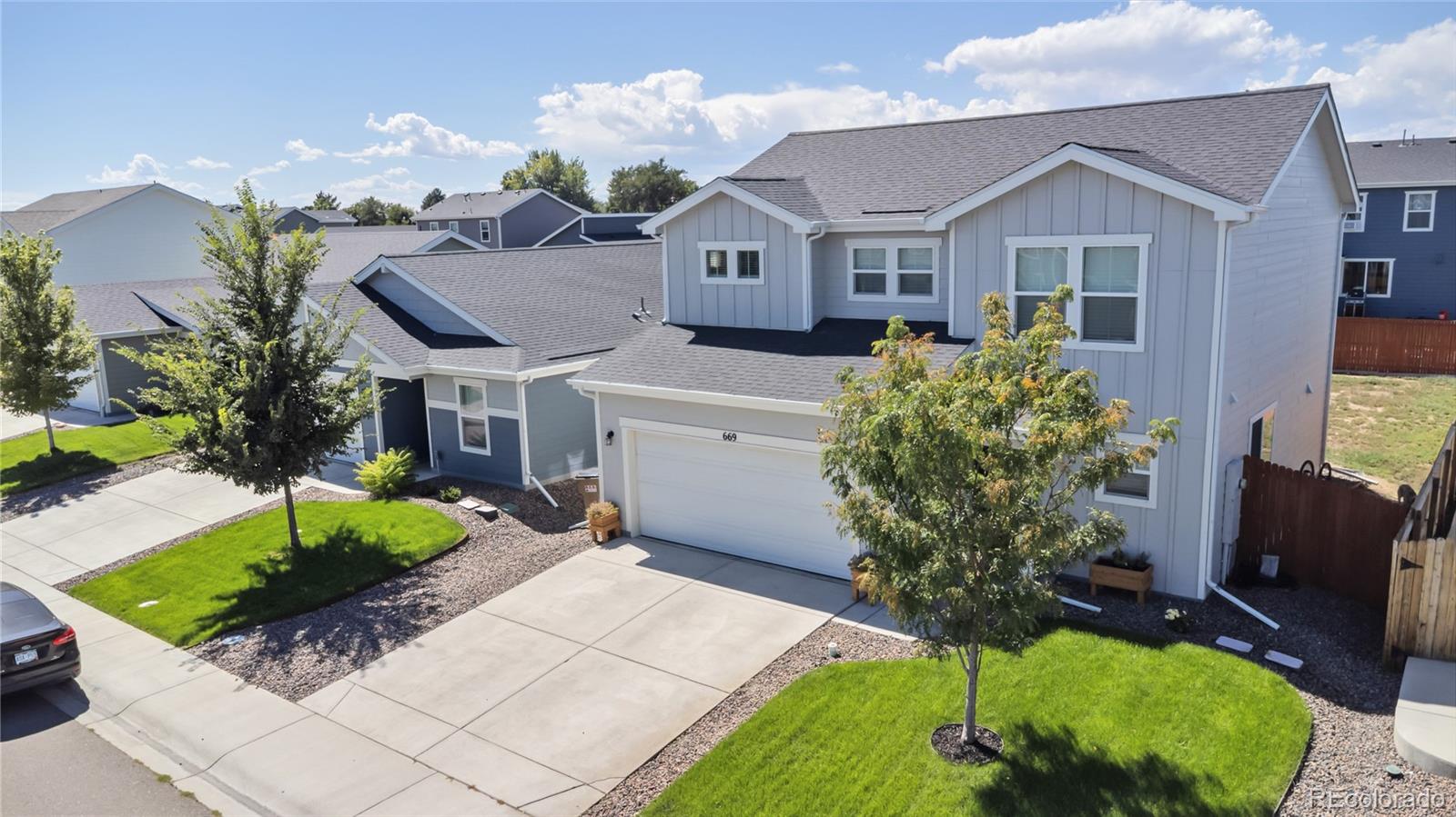 669 South Hoover Avenue Fort Lupton, CO 80621 - Photo 2 of 24 a front view of a house with garden
