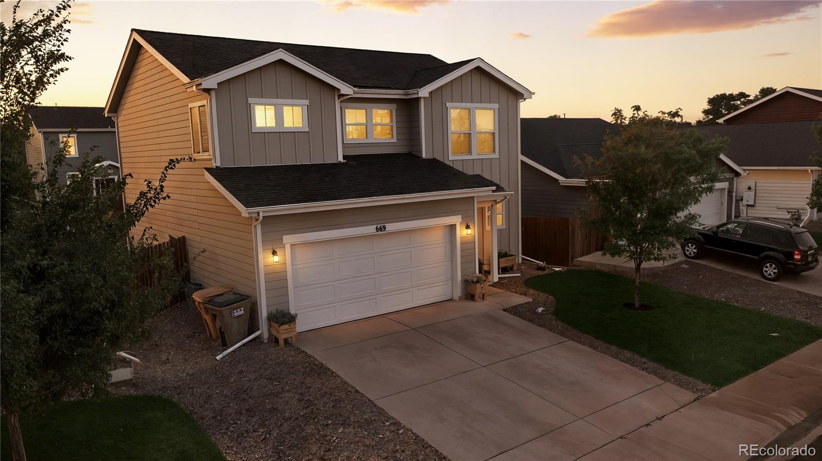 669 South Hoover Avenue Fort Lupton, CO 80621 - Photo 22 of 24 a front view of a house with a yard