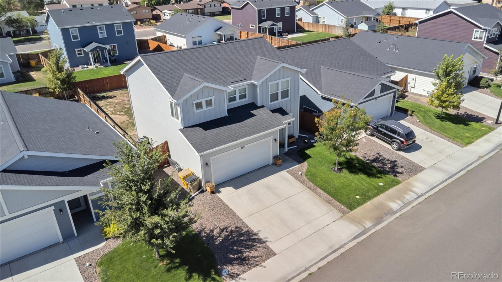 669 South Hoover Avenue Fort Lupton, CO 80621 - Photo 23 of 24 an aerial view of a house with a yard potted plants and large tree