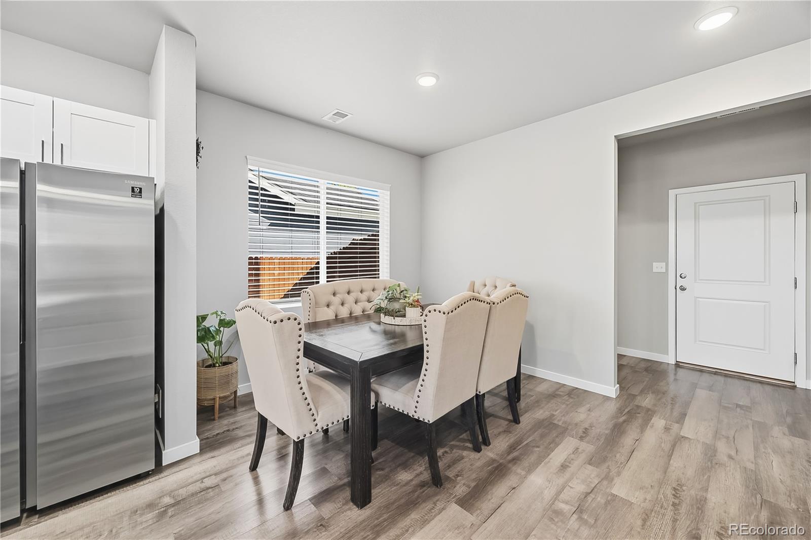 669 South Hoover Avenue Fort Lupton, CO 80621 - Photo 5 of 24 a view of a dining room with furniture window and wooden floor