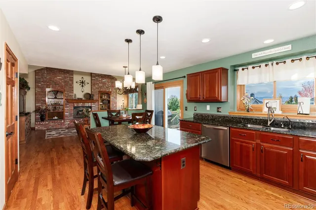 a view of a dining room with furniture wooden floor and chandelier