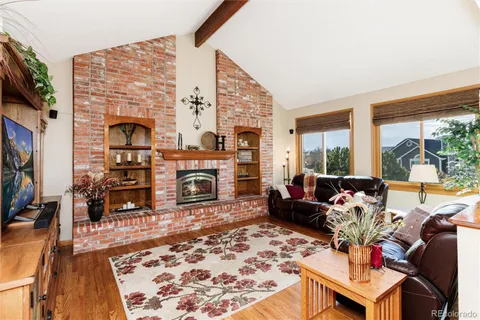 a living room with furniture large window and a fireplace