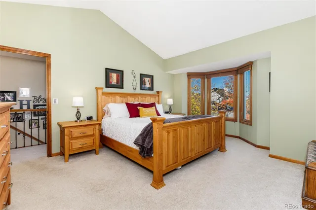 a living room with furniture a view of bedroom and a large window