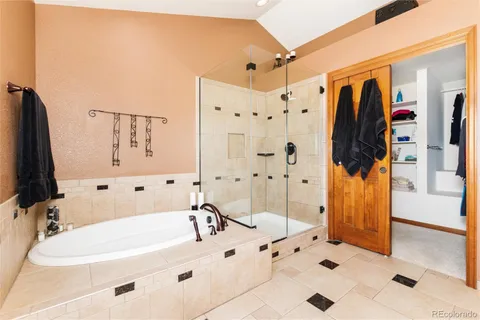 a bathroom with a bathtub sink and mirror