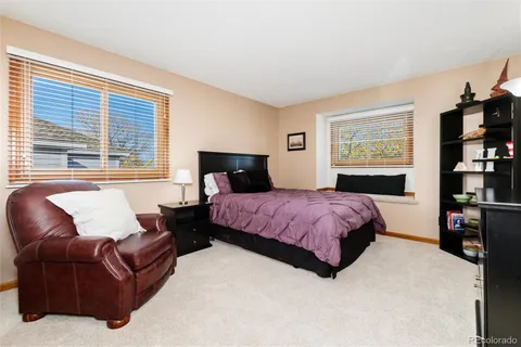 a spacious bedroom with a bed window and a couch