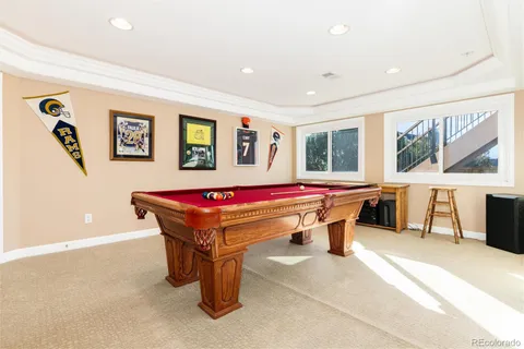 a room with pool table and windows