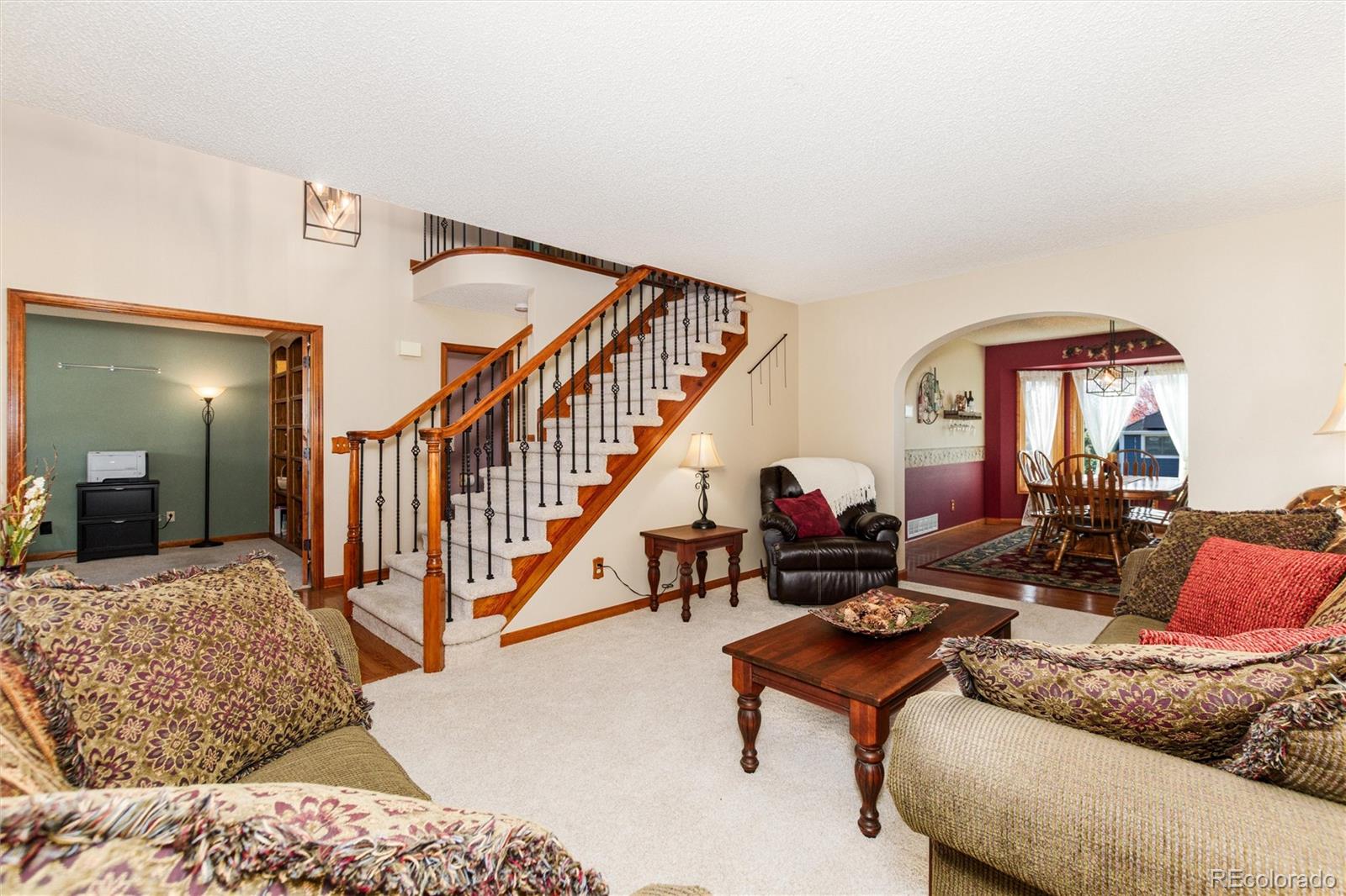 9635 Cherryvale Drive Highlands Ranch, CO 80126 - Photo 8 of 46 a living room with furniture and a wooden floor