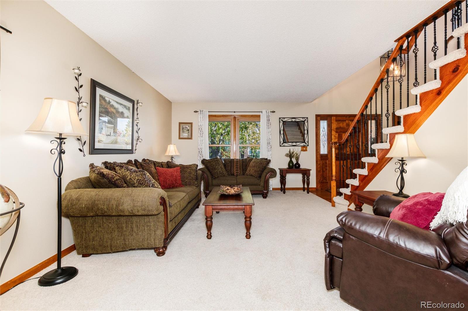 9635 Cherryvale Drive Highlands Ranch, CO 80126 - Photo 9 of 46 a living room with furniture or stairs and a couch